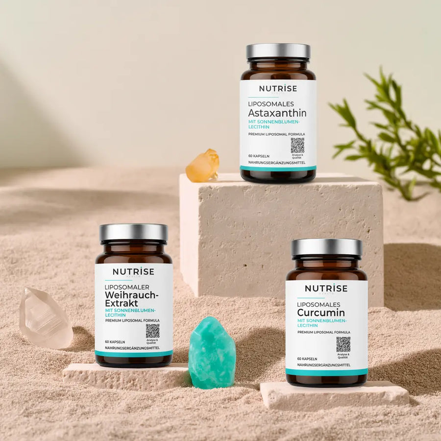 Liposomales Astaxanthin, Curcumin und Weihrauch-Extrakt von Nutrise Health auf Kalkstein mit weißen und türkisen Kristallen.